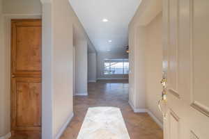 Hallway with light tile patterned floors