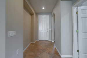 Entry with art niche with light tile patterned flooring