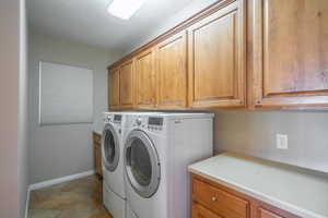 Clothes washing area with washing machine and clothes dryer and cabinets