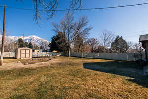 View of yard with a mountain view and a shed