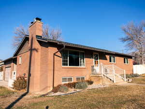 View of front of property with a front lawn and a garage