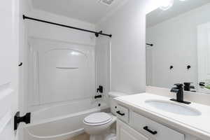 Full bathroom with ornamental molding, toilet, tile patterned floors, shower / bath combination, and vanity