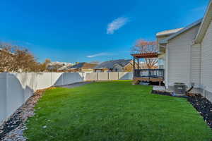 View of yard featuring a deck and central AC unit