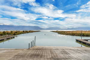 Dock area featuring a water and mountain view