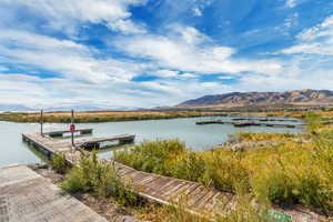 Dock area with a water and mountain view