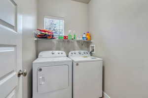 Clothes washing area featuring separate washer and dryer