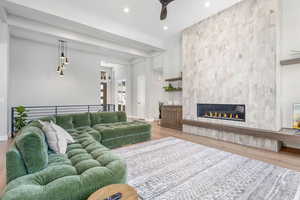 Modern Fireplace Tiled to the Ceiling with Custom Cabinets & Floating Shelves