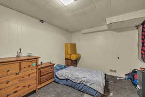 Bedroom featuring wood walls