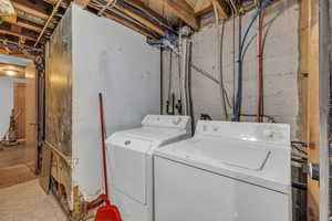 Clothes washing area featuring washer and dryer