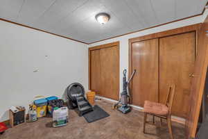 Exercise room featuring ornamental molding