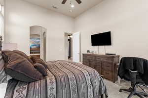 Primary Bedroom with ceiling fan and light carpet