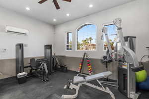 Exercise room with a wall unit AC and ceiling fan