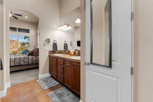 Bathroom with ceiling fan, vanity, and tile patterned floors