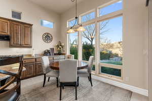 Tiled dining area with an inviting chandelier