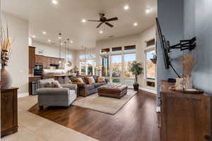 Living room with ceiling fan and light hardwood / wood-style flooring