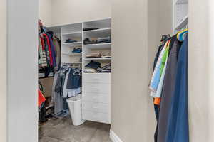 Walk in closet with carpet floors