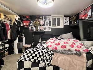 Carpeted bedroom with a closet