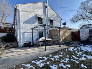 View of snow covered back of property