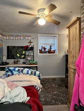 Bedroom featuring a textured ceiling and ceiling fan