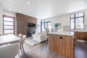 Kitchen featuring a kitchen island, tasteful backsplash, plenty of natural light, and dark wood-type flooring