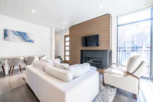 Living room with a large fireplace and hardwood / wood-style flooring