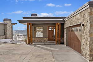 Doorway to property featuring a mountain view and a garage