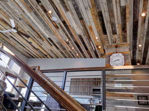 Room details featuring vaulted ceiling, barn wood and steel.