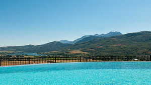 View of swimming pool with a mountain view