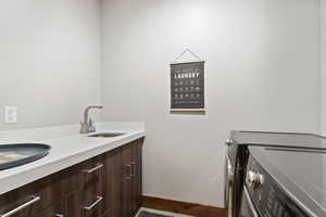 Bathroom with washing machine and dryer and sink