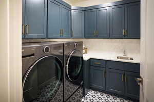 Laundry room with full upper and lower cabinets, including laundry sink and tiled backsplash.