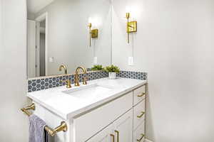 Elegant touches include 9" offset faucets, upgraded hardware, sconces, and honey-comb tile trim that matches the shower.