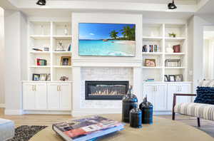 Great Room media center with built-in shelving, cabinets, and gas fireplace.