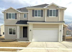 View of front of property with a garage and central AC