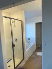 Bathroom with independent shower and bath and concrete floors