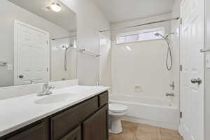 Full bathroom with tile patterned flooring, vanity, toilet, and shower / tub combination