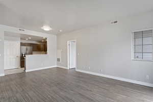 Unfurnished living room featuring hardwood / wood-style flooring