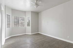 Spare room featuring wood-type flooring and ceiling fan