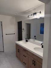 Bathroom with a washtub, a textured ceiling, and vanity