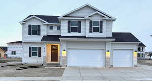 View of front facade featuring a garage