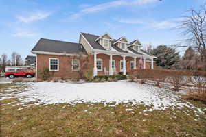 Cape cod-style house with a porch