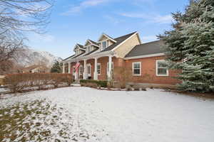 New england style home featuring a mountain view and a porch