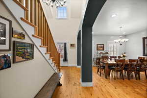 Interior space with light hardwood / wood-style flooring, plenty of natural light, and a notable chandelier