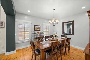 Dining space featuring an inviting chandelier and light hardwood / wood-style floors