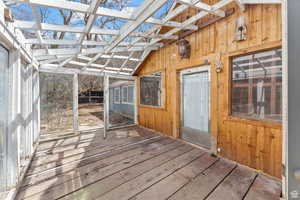 Unfurnished sunroom with lofted ceiling with beams