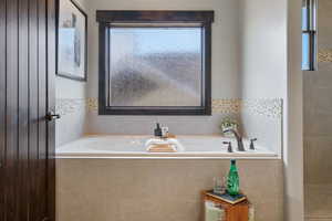 Bathroom featuring tiled bath