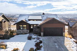 View of front of house featuring a mountain view and a garage