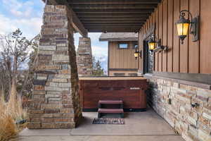 View of patio with a hot tub