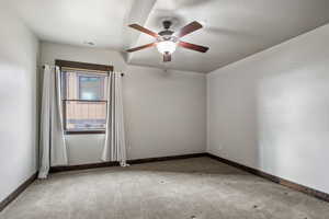 Carpeted spare room with ceiling fan