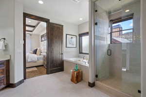 Bathroom featuring tile patterned floors, vanity, and plus walk in shower