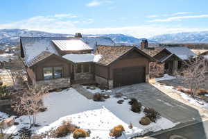 View of front of property with a mountain view and a garage